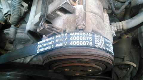 1991 Ford F-150 - Close-up of a Continental Multi V serpentine belt and pulleys on an engine.