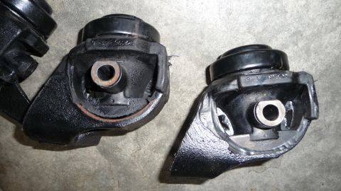 1993 Mazda MX-3 - Close-up of two engine mounts, possibly for a Mazda, showing their construction.