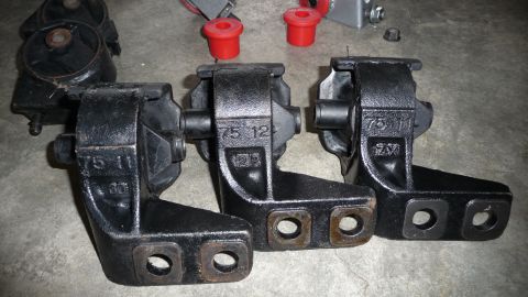 1993 Mazda MX-3 - Three engine mounts are shown, with part numbers visible on each. Red bushings are also present in the background.