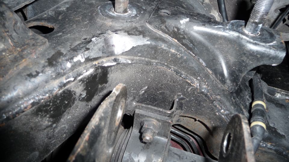 Engine bay bracket with bolts and hoses