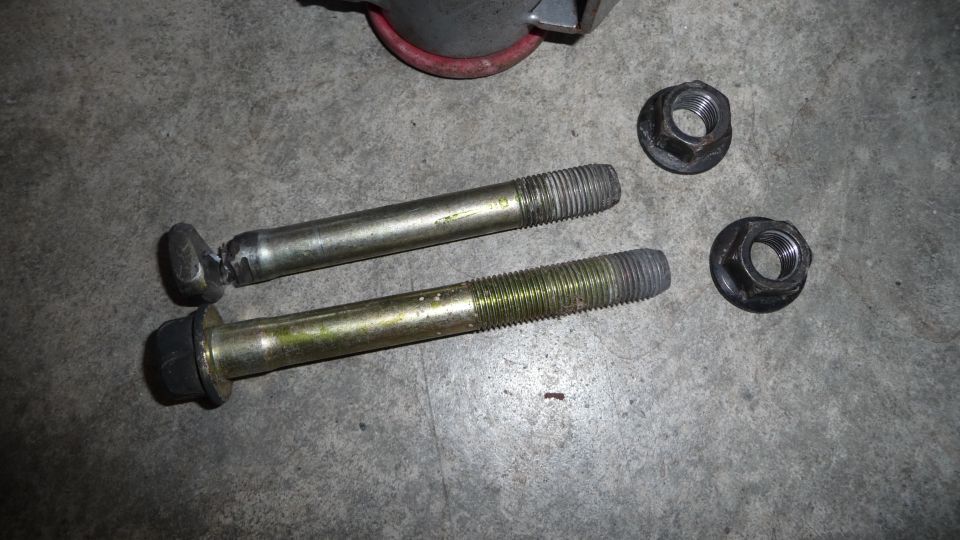 Two bolts and nuts on concrete floor