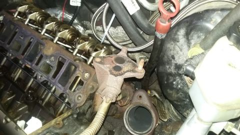 2000 Pontiac Grand Prix - Close-up view of engine components, including the intake manifold and exhaust system parts.