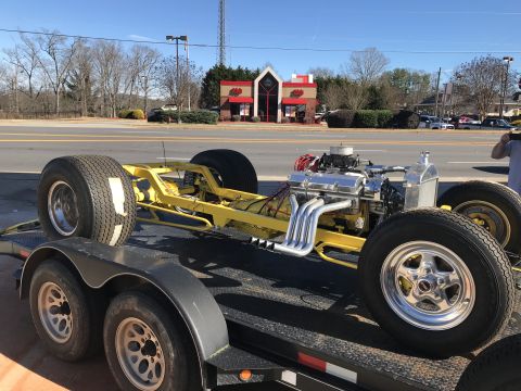 1923 Ford Model T - A custom hot rod chassis, stripped down and ready for assembly, is transported on a trailer.