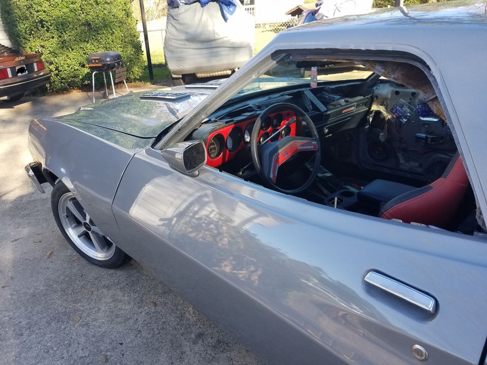 Silver 1976 Ford Ranchero interior and side view, red accents