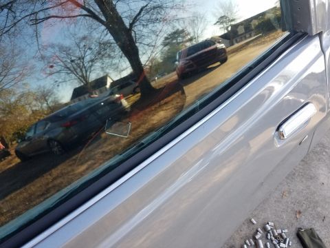 1976 Ford Ranchero - Reflection of cars and houses in a car window, with a tree visible.