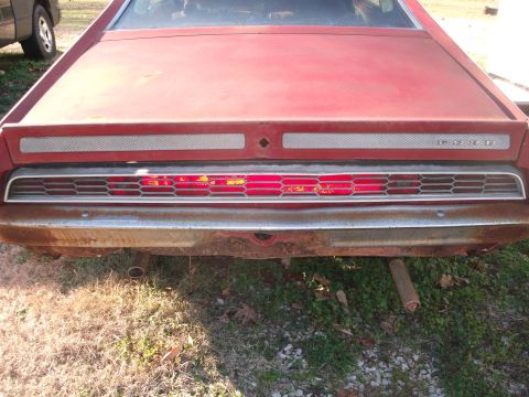 1970 Ford Torino - Rear view of a red 1970 Ford Torino, showing its distinctive taillight design and chrome bumper.