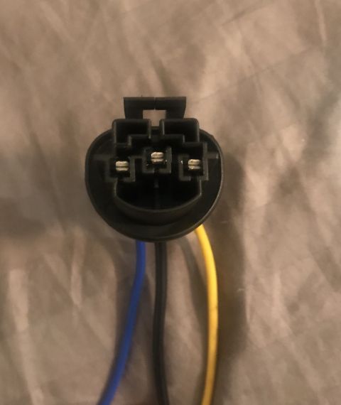 1995 Ford Bronco - This is a close-up view of an automotive electrical connector with three wires.