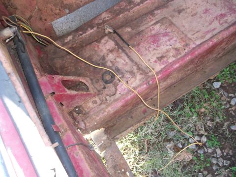1970 Ford Torino - Interior floor pan shows significant rust and exposed wiring, indicating wear and tear.
