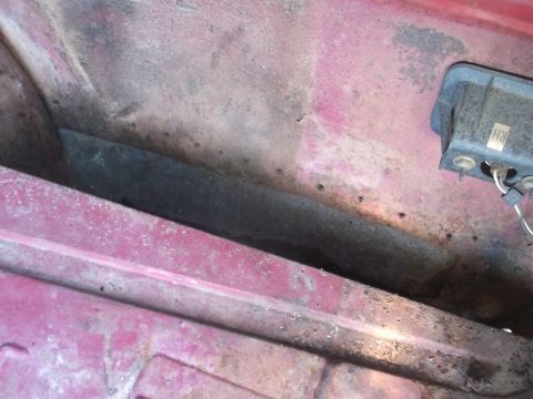 1970 Ford Torino - This image shows a section of a car's interior, possibly under the dashboard or in the trunk, with visible wear and tear.