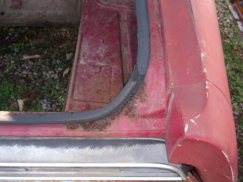 1970 Ford Torino - The door frame and sill of a red vehicle show significant rust and wear.