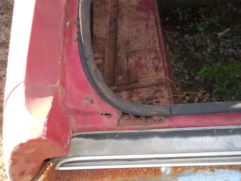 1970 Ford Torino - Close-up of a damaged car door frame, showing rust and a deteriorated rubber seal.