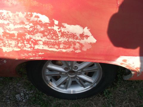 1970 Ford Torino - Close-up of a 1970 Ford Torino's rear fender and wheel, showing paint damage.