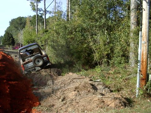 1985 Ford Bronco - This SUV appears to be stuck in a ditch off-road.