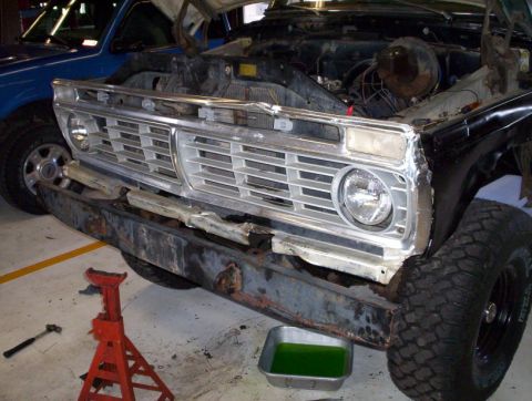 1978 Ford Bronco - A 1978 Ford Bronco is undergoing repairs, with its front end disassembled and hood open.