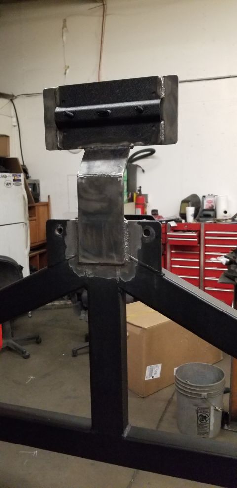 1996 Ford Bronco - A close-up view of a custom-fabricated metal structure, likely a part of a vehicle modification. The structure features welded joints and m…