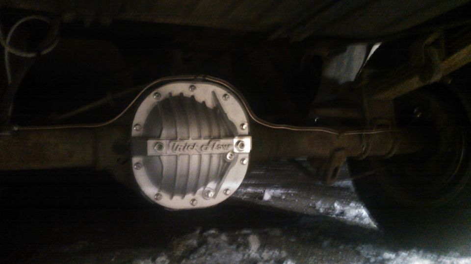 Underside of a vehicle showing a Trick Flow differential cover and copper brake lines.