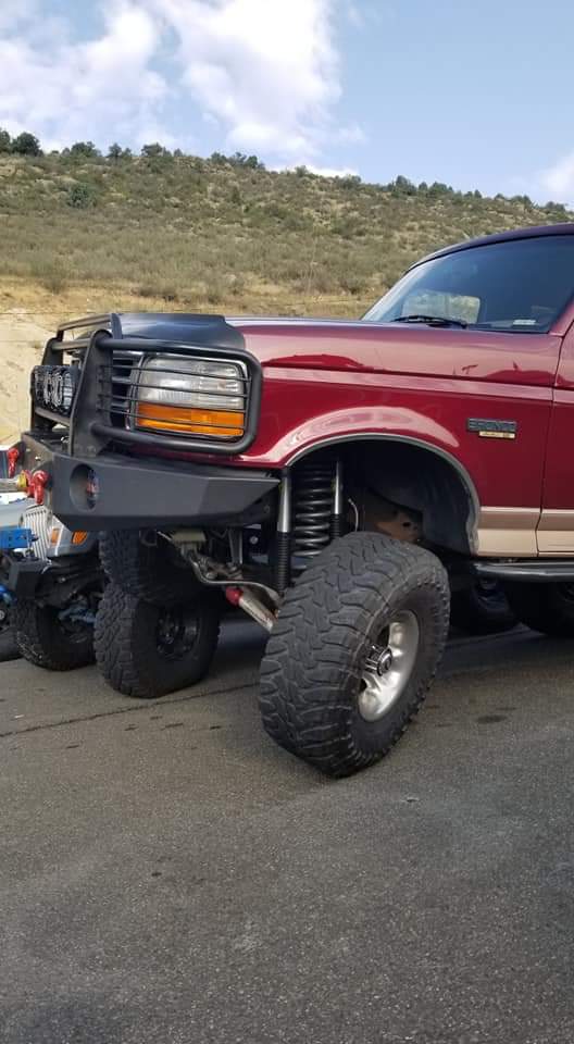Lifted dark red 1996 Ford Bronco front quarter panel and custom bumper