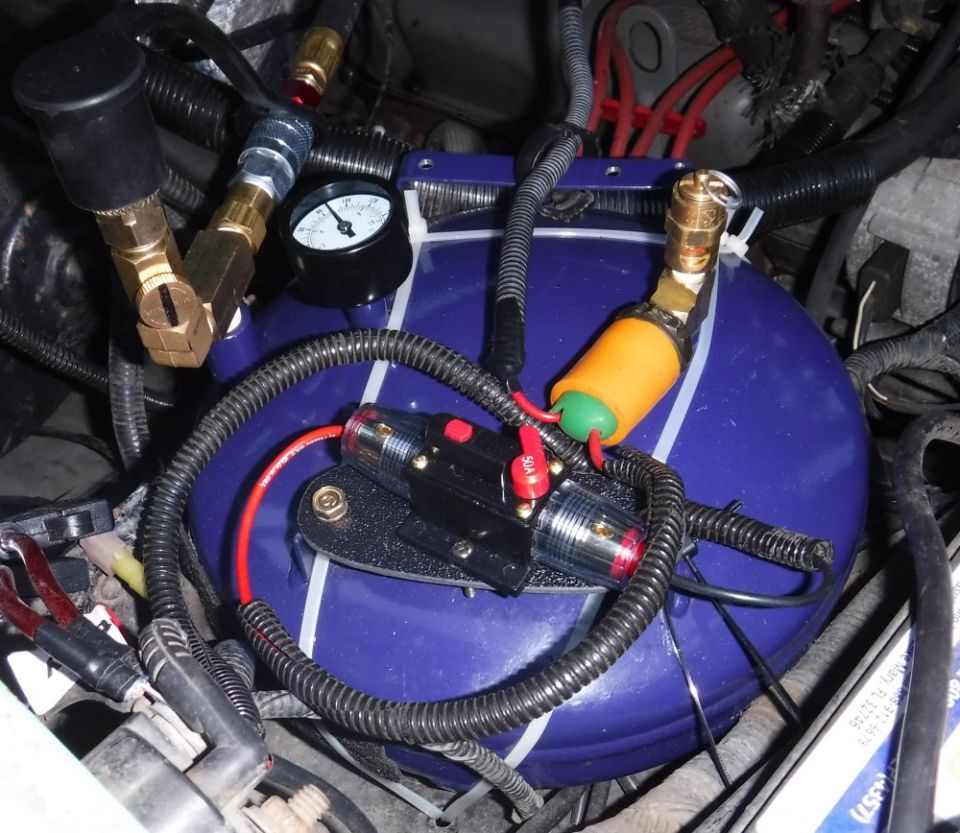Mounting plate added for the circuit breaker, excess wiring tidied up, fittings cinched up tighter ... still an itsy bitsy leak somewhere left to find.
