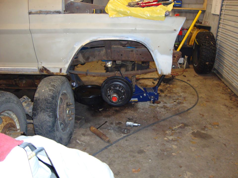 Pickup truck rear suspension and frame with jack and oil pan