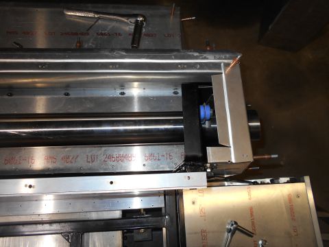 1992 Ford Bronco - A close-up view of the internal mechanism of a vehicle, possibly a printing press or industrial machine, showing metal rollers, brackets, a…