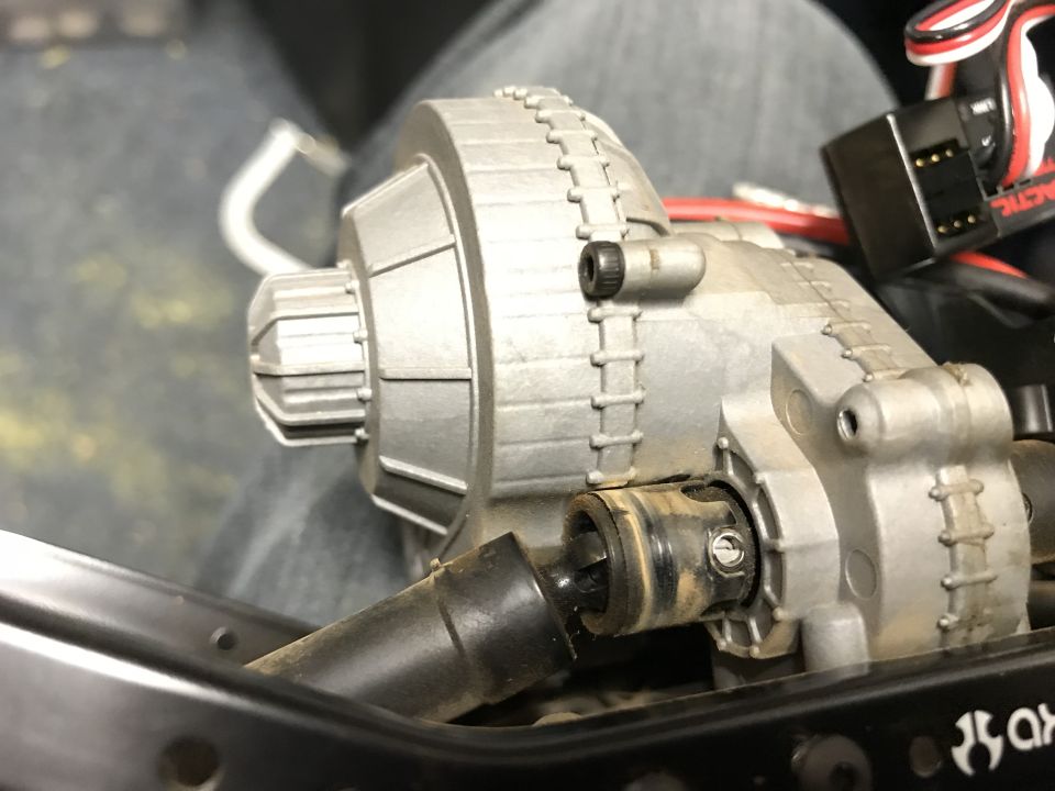 RC car silver differential housing and driveshaft, with black connector and wires.