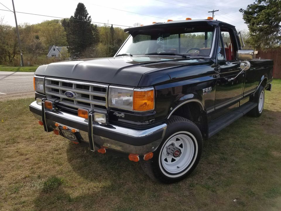 1988 Ford F-150 pickup truck, front 3/4 view, black