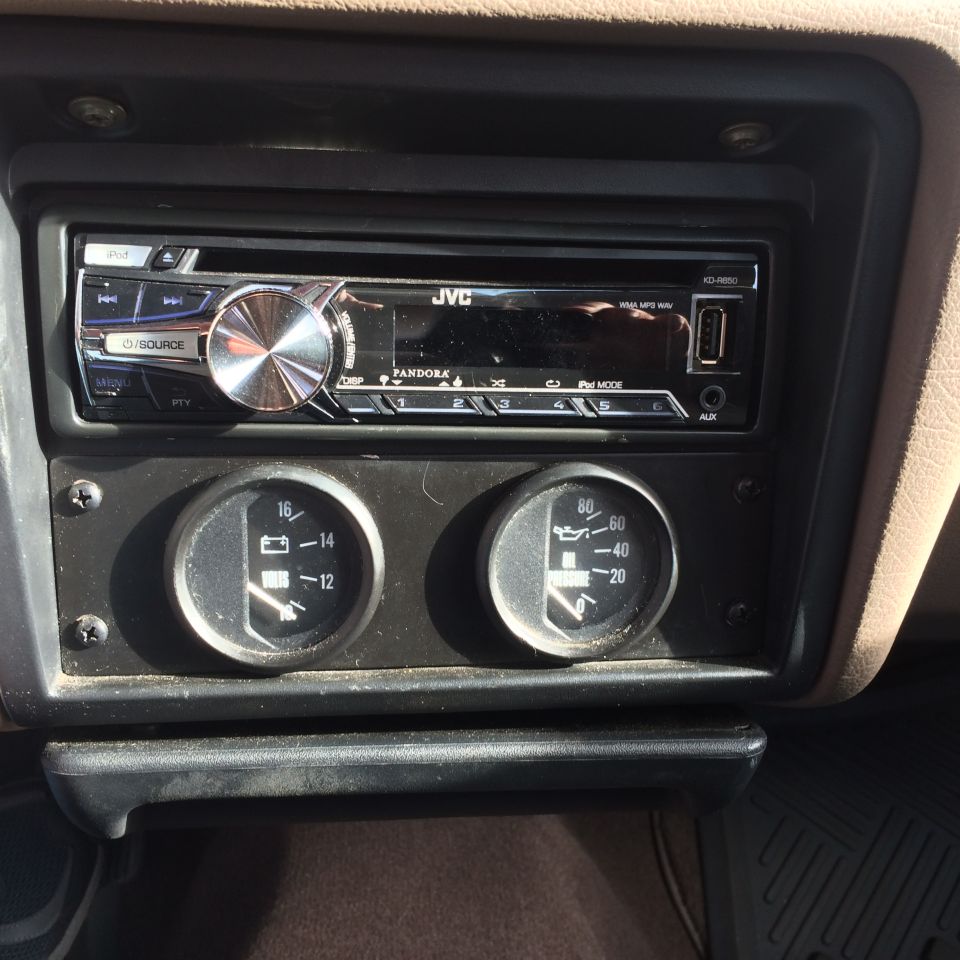 1995 Ford Taurus interior with JVC stereo and battery voltage and oil pressure gauges.