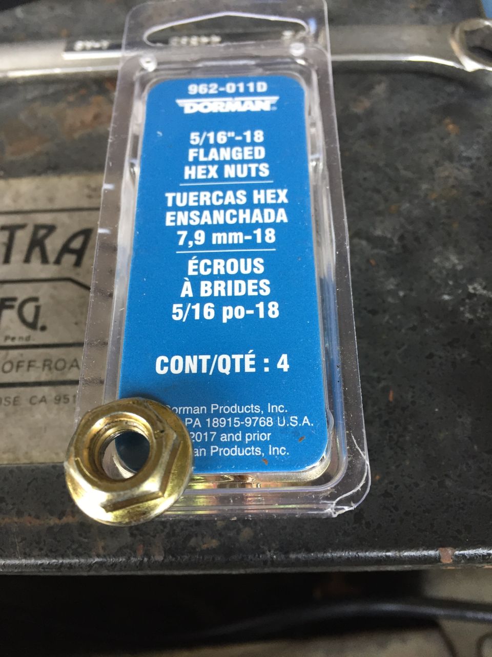 Package of Dorman 5/16"-18 flanged hex nuts with one nut in front.