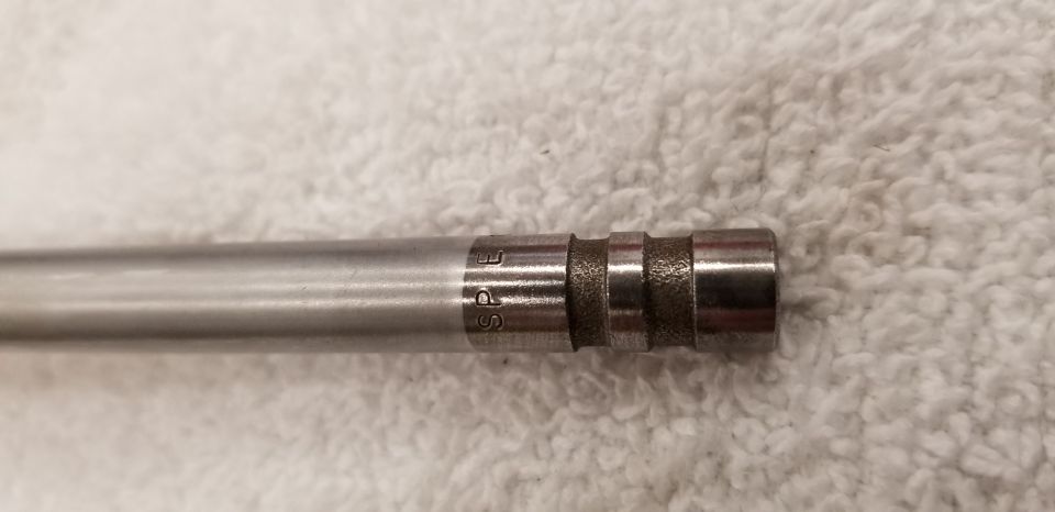 Metal part with SPE stamped on it and grooved rings