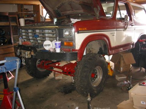 1985 Ford Bronco - This Ford Bronco appears to be undergoing a solid axle swap modification in a garage setting.