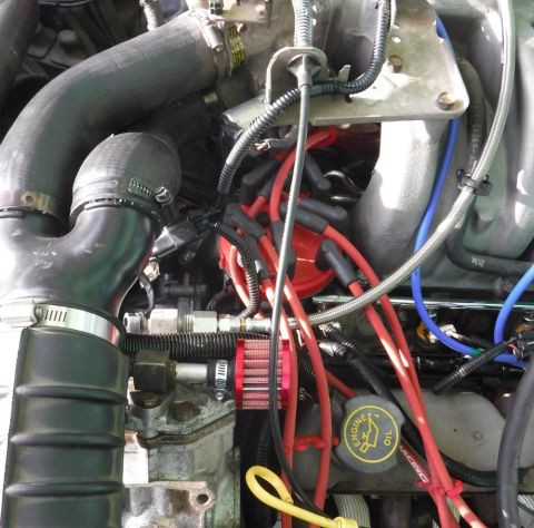 1992 Ford Bronco - Compressor plumbing finalized with Rotolock flange fitting on discharge port, and SS braided, teflon lined hose all the way to the tank.
