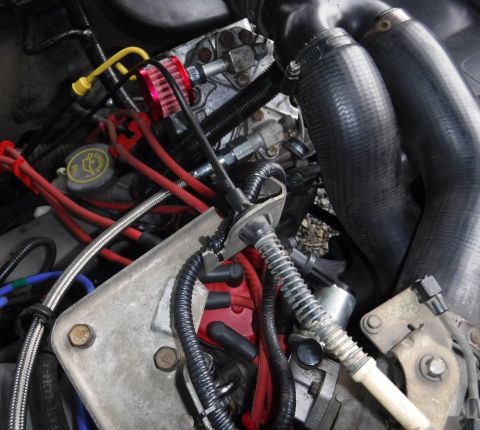 1992 Ford Bronco - Compressor plumbing finalized with Rotolock flange fitting on discharge port, and SS braided, teflon lined hose all the way to the tank.