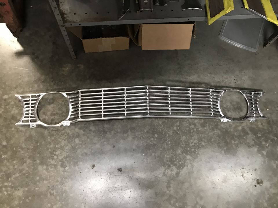Chrome front grille with horizontal bars and headlight cutouts