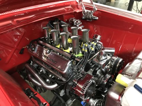1964 Ford Fairlane - Close-up view of a highly polished Ford Racing V8 engine with individual throttle bodies, chrome valve covers, and custom headers installed…