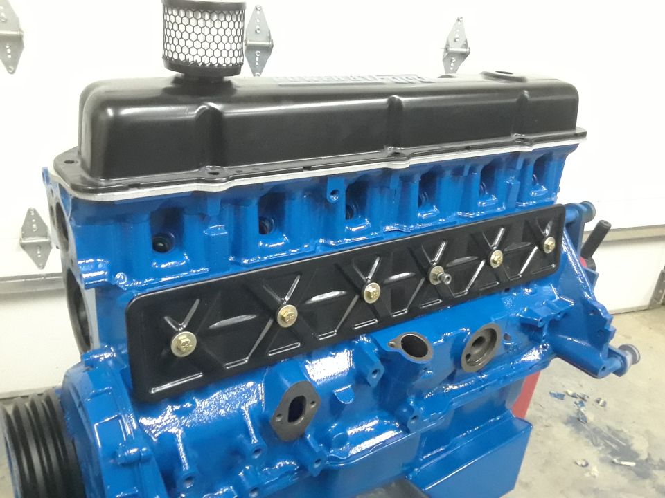 Blue engine block with black valve cover and air filter