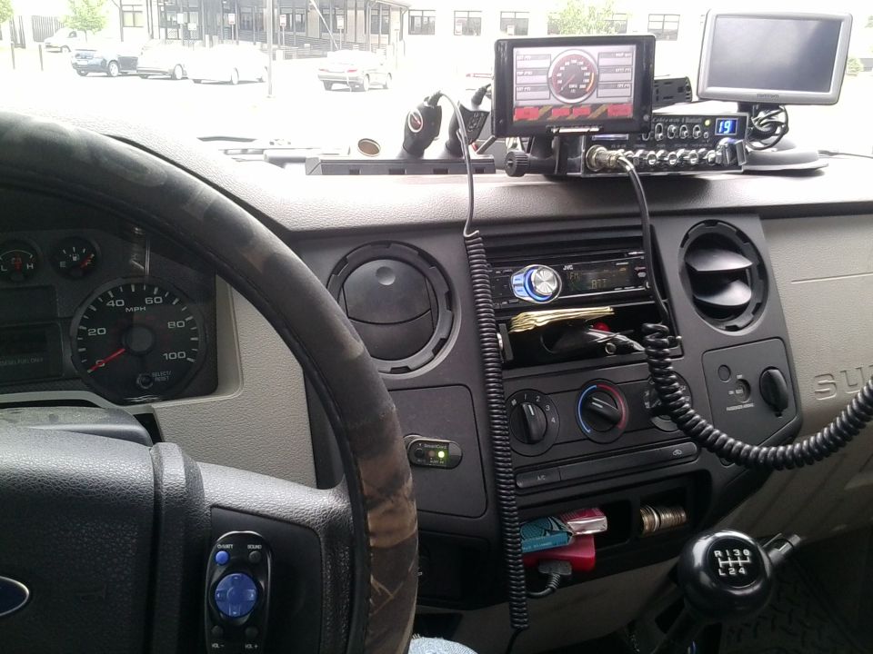 Dash of a Ford Super Duty with CB radio, gauges and aftermarket stereo