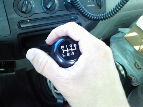 2008 Ford F-250 - Close-up of a hand operating an automatic gear shifter inside a vehicle.