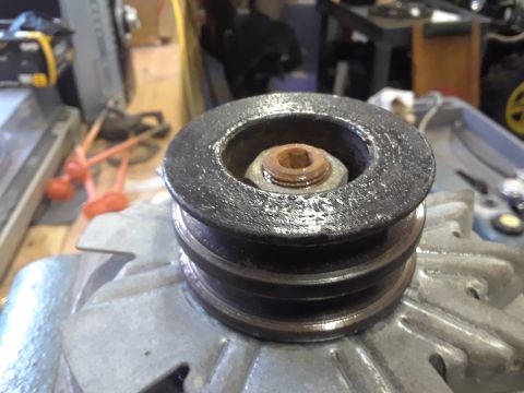1985 Ford Bronco - Close-up of an alternator pulley, showing the central hex nut and washer, with a watermark for Supermotors.net.