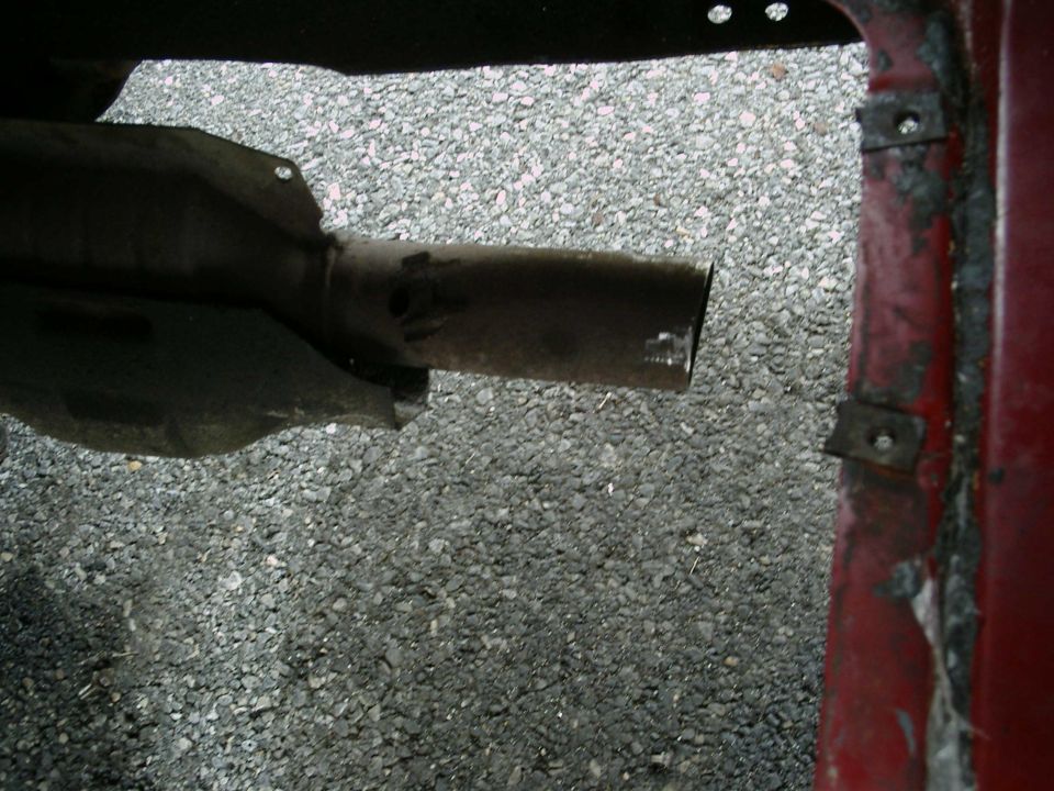 exhaust pipe extending from under a vehicle