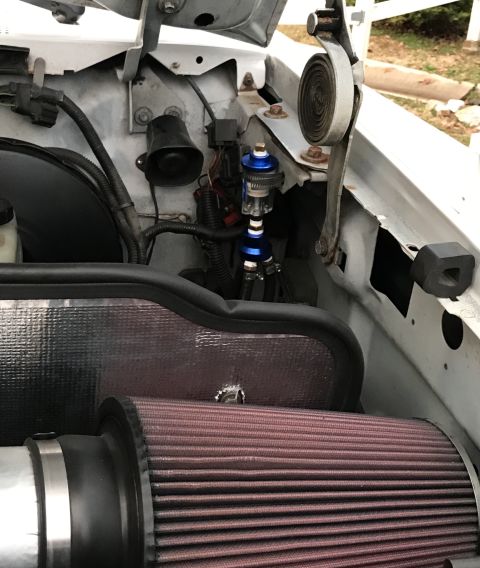 1995 Ford Bronco - Engine bay of a 1995 Ford Bronco shows an aftermarket air intake and a blue fuel filter.