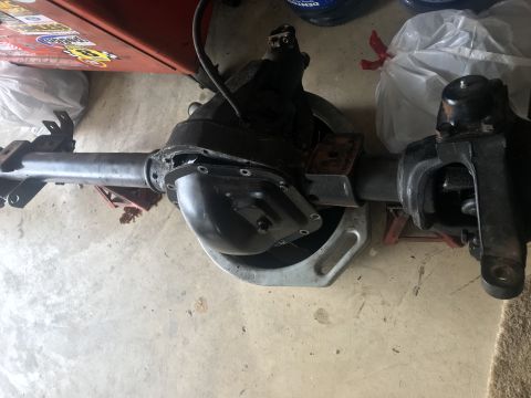 1989 Ford Bronco - Ford Dana 60 rear axle assembly shown on jack stands in a garage.