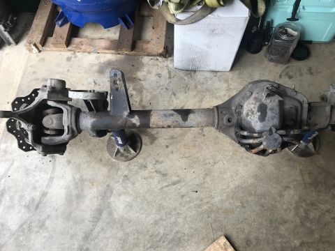1989 Ford Bronco - A heavy-duty Ford Dana 60 axle assembly is shown resting on the floor, likely for a rebuild or modification.