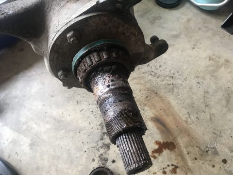 1989 Ford Bronco - Close-up of a heavily rusted wheel hub assembly, showing wear on the splined shaft and bearing.