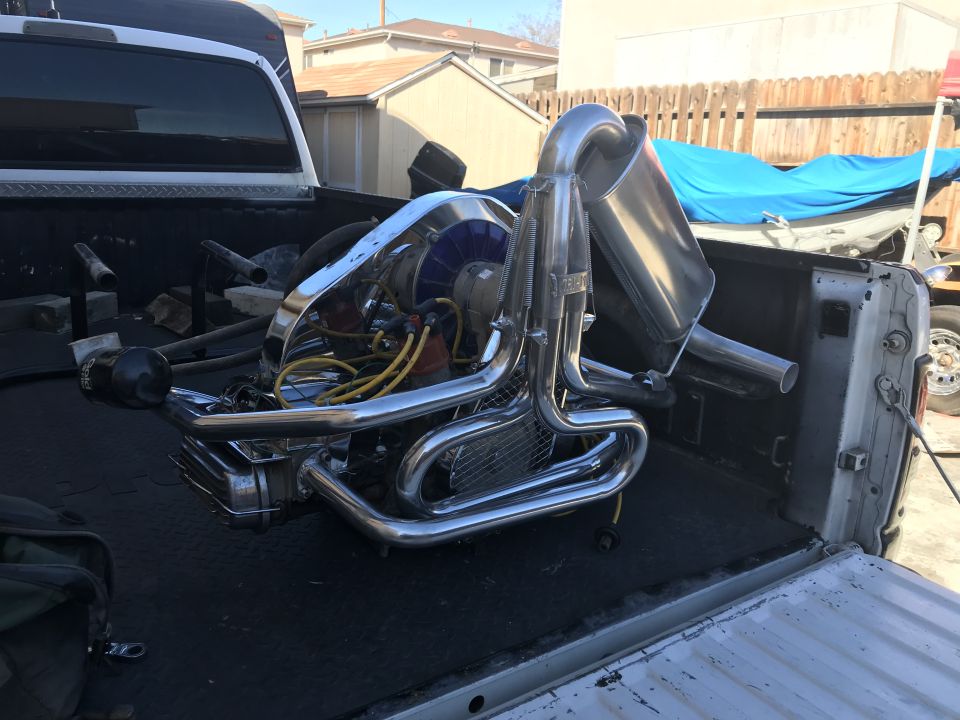 Volkswagen Beetle engine with chrome exhaust pipes and blue fan shroud