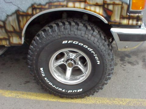 1989 Ford Bronco - Close-up of a BFGoodrich Mud-Terrain tire and wheel on a vehicle with unique, weathered-looking custom paint.