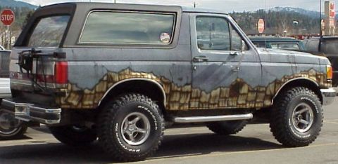 1989 Ford Bronco - This Ford Bronco features a unique paint scheme depicting mountains and a rustic texture.
