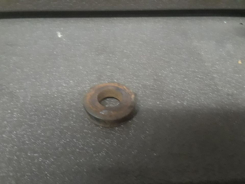 Rusty metal washer on a dark surface