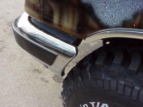 1989 Ford Bronco - The side view of a 1989 Ford Bronco shows its chrome bumper and off-road tire.