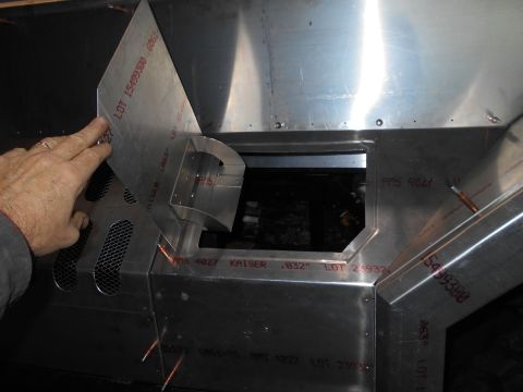 1992 Ford Bronco - A person's hand is shown adjusting a piece of sheet metal that is part of a custom build. Red lettering with lot numbers and measurements i…