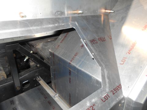 1992 Ford Bronco - A close-up view of custom aluminum fabrication inside a vehicle, possibly a truck or SUV, showing bent sheet metal and stamped lot numbers.
